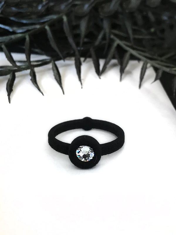 Simple black ring with white swarovski crystal, displayed on a white background with gothic black foliage. 3d printed jewelry by Hypnovamp.
