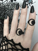 Graphic 3d printed black crescent moon ring displayed on a gothic hand with black lace and long pointy black Vampira nails