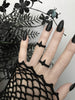 Matte black 3d printed goth ring with geometric pointy spike design, worn on a gothic model's hand with long pointy black nails.