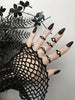 Close up of 6 simple matte black rings with white swarovski crystal stones, displayed on a gothic model's hand with long black nails. 3d printed jewelry by Hypnovamp.