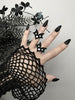 3 Matte black bat wing rings with white swarovski crystal stones, displayed on a gothic model's hand with long black nails. 3d printed jewelry by Hypnovamp.