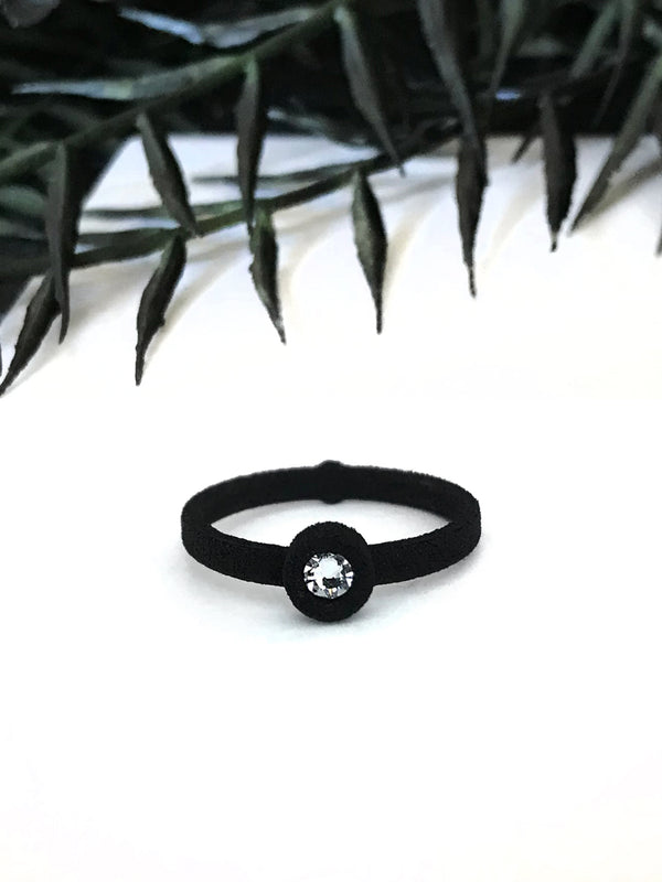 Simple black ring with white swarovski crystal, displayed on a white background with gothic black foliage. 3d printed jewelry by Hypnovamp.