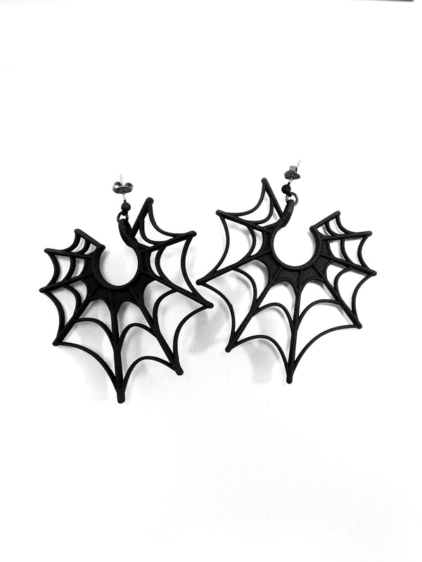 Large black spiderweb earrings displayed against a white background. 3d printed jewelry with hypoallergenic stainless steel posts.