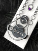 Backside of vintage style silver necklace with star and diamond symbols and a purple amethyst. Witchy art deco jewelry handmade by Salem Massachusetts jewelry designer, Hypnovamp.