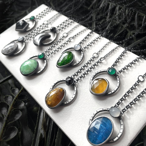 Handmade silver gemstone necklaces featuring black onyx, midnight quartzite, clear quartz moon, chrysoprase, chrome diopside, petra tourmaline, montana agate, and blue apatite. Witchy jewelry handcrafted in Salem Massachusetts by jewelry designer Hypnovamp.