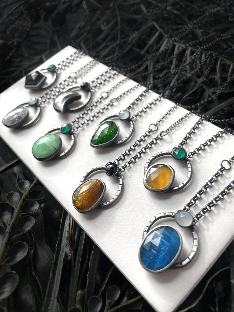 Handmade silver gemstone necklaces featuring black onyx, midnight quartzite, clear quartz moon, chrysoprase, chrome diopside, petra tourmaline, montana agate, and blue apatite. Witchy jewelry handcrafted in Salem Massachusetts by jewelry designer Hypnovamp.